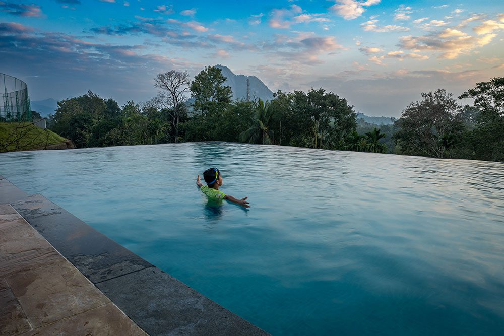 Luxury swimming pool at Lords 83 Resort in Wayanad surrounded by scenic hills and peaceful natural greenery