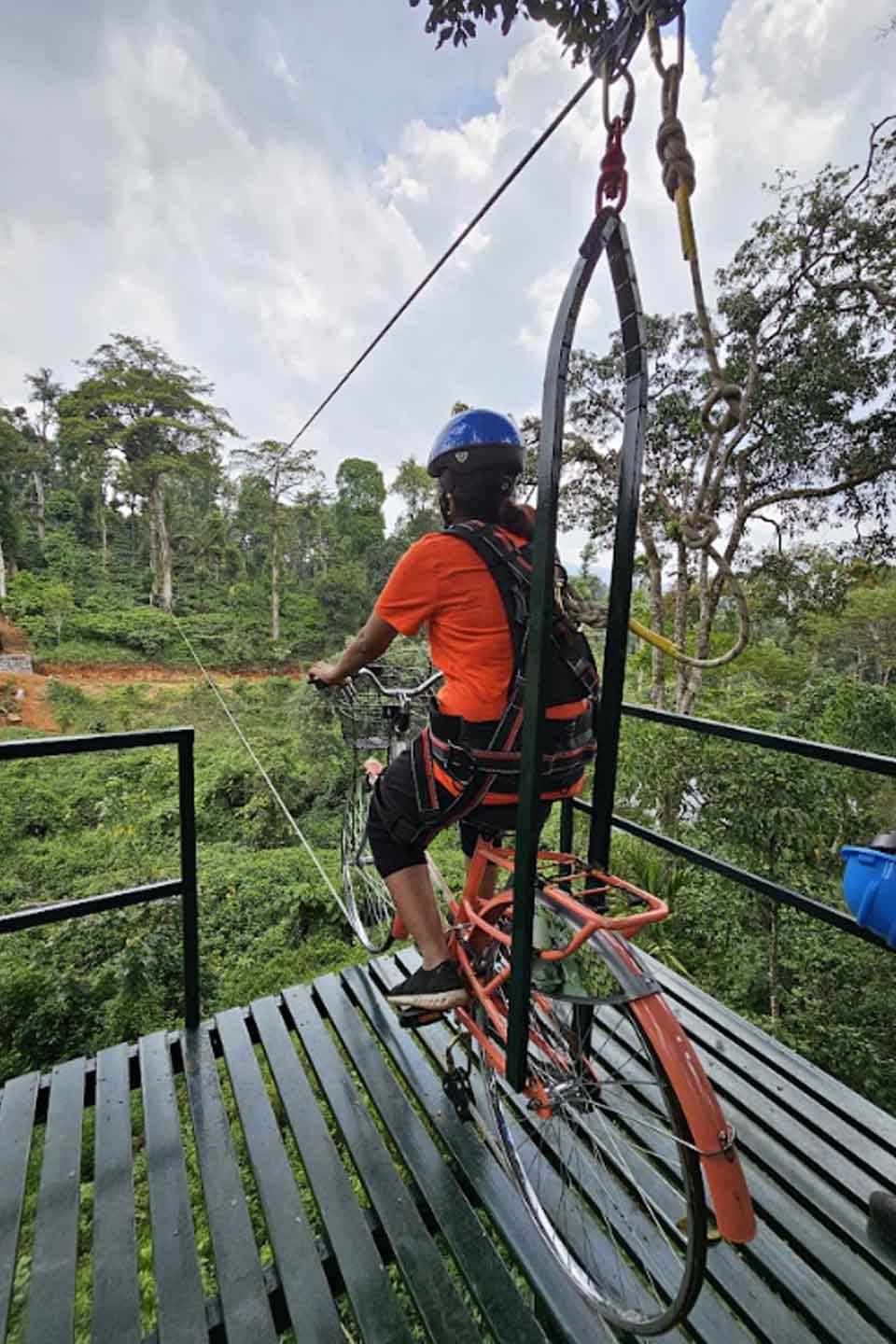 Guests enjoying adventure activities at Misty Woods Resort Coorg, including trekking, kayaking, rope activities, and outdoor sports amidst nature.